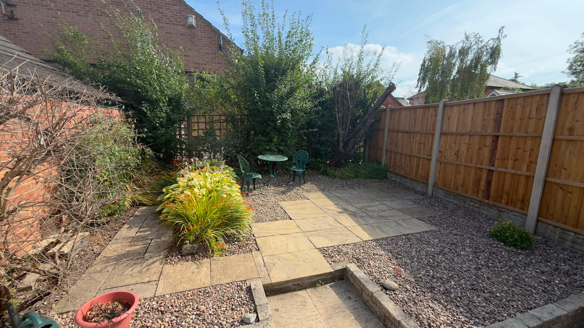 Private courtyard garden with paved patio, planting and bistro seating