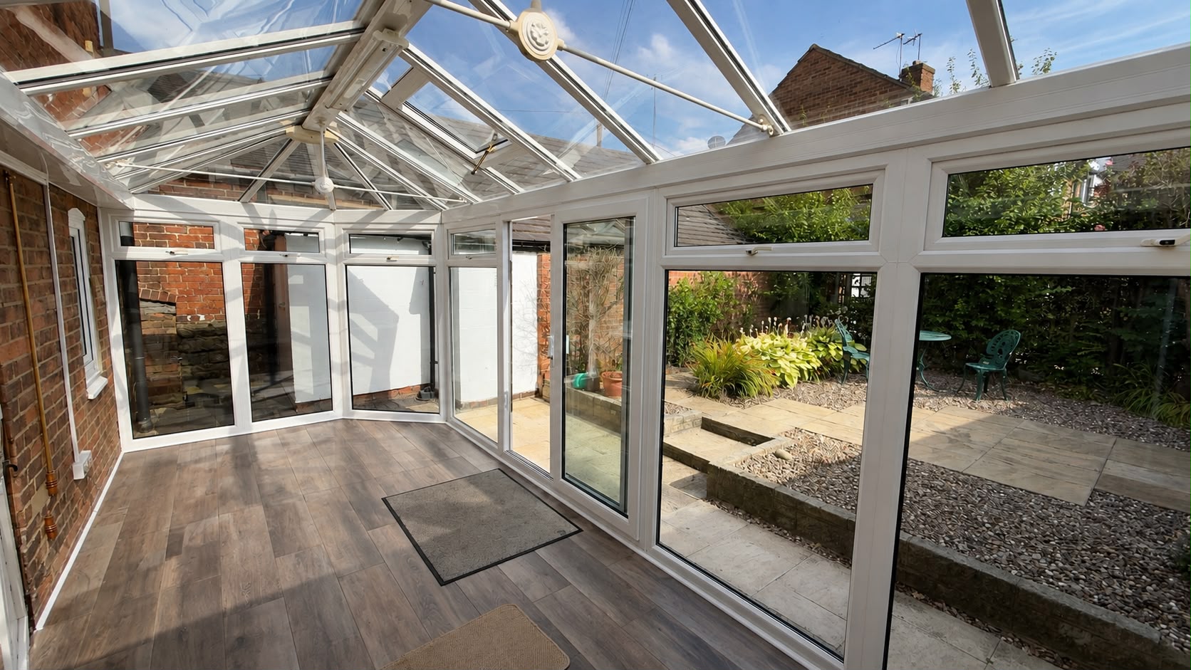 Glass-roofed garden room opening onto the courtyard garden
